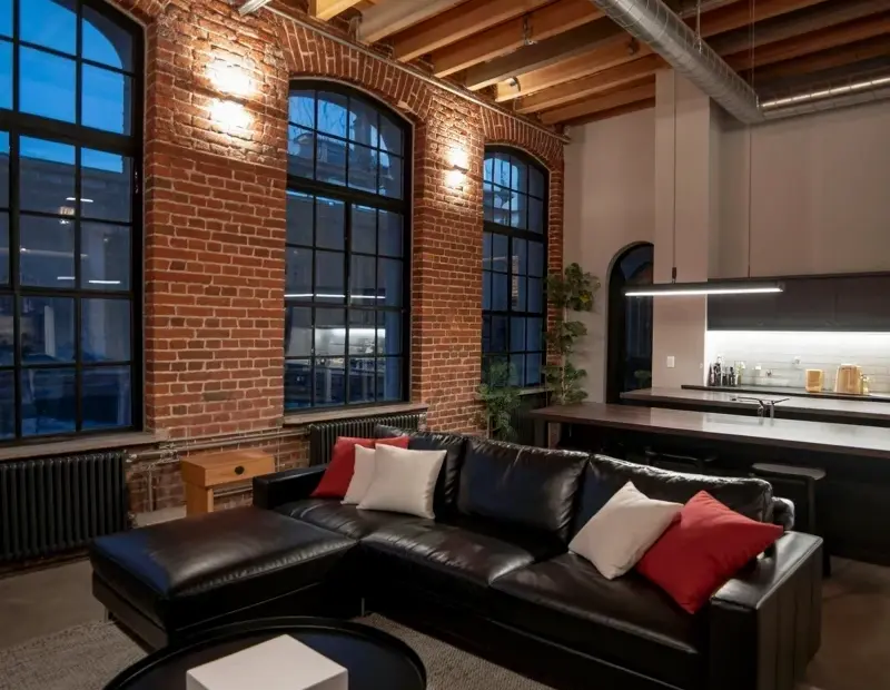 Before & After: High-End Industrial Loft Living Room with Brick Walls and Arched Windows